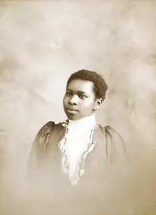 Studio portrait of young woman, c1890-c1899. Creators: M Yogg, Unknown