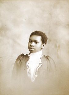 Studio portrait of young woman, c1890-c1899. Creators: M Yogg, Unknown