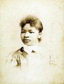 Studio portrait of young woman, head turned to her right, (1880-1900?). Creators: Stanton & Burdick, Unknown