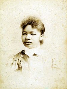 Studio portrait of young woman, head turned to her right, (1880-1900?). Creators: Stanton & Burdick, Unknown