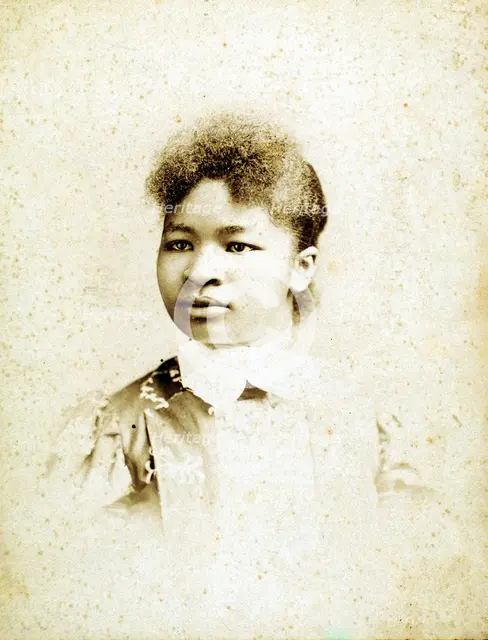 Studio portrait of young woman, head turned to her right, (1880-1900?). Creators: Stanton & Burdick, Unknown.