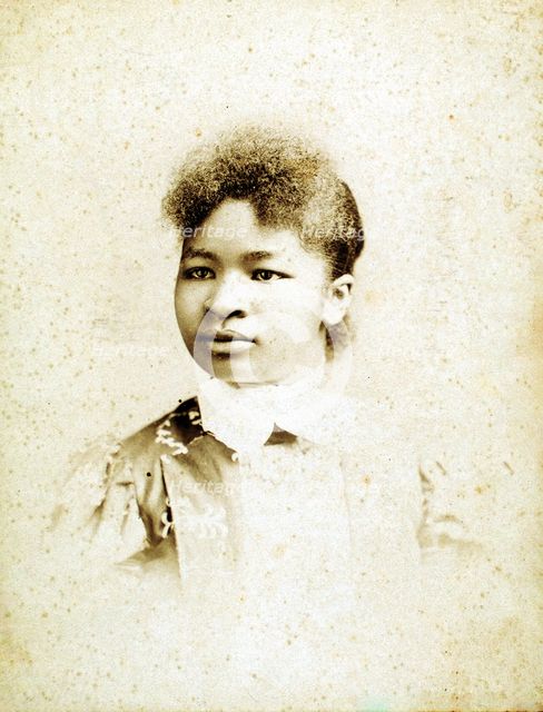 Studio portrait of young woman, head turned to her right, (1880-1900?). Creators: Stanton & Burdick, Unknown.