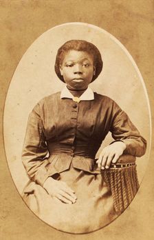 Studio portrait of young woman with thin ribbon around neck, (1880-1889?). Creator: A. T. Hunt