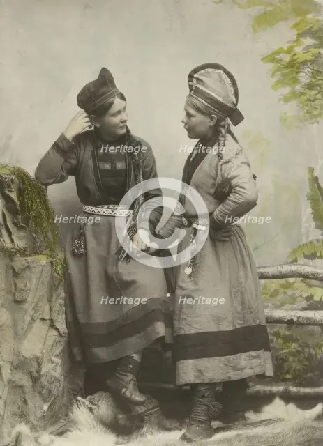 Studio portrait:Two young Sami women dressed in black, 1890-1899. Creator: Helene Edlund.