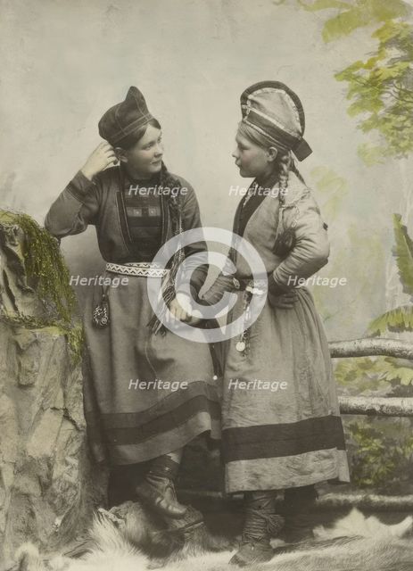 Studio portrait:Two young Sami women dressed in black, 1890-1899. Creator: Helene Edlund.