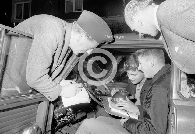 Studying the map in a car rally, Landskrona Motor Club, Sweden, 1965. Creator: Unknown.