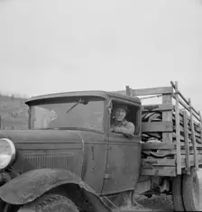 Stump farmer bringing load of slab wood to sell in town, Bonner County, Idaho, 1939. Creator: Dorothea Lange
