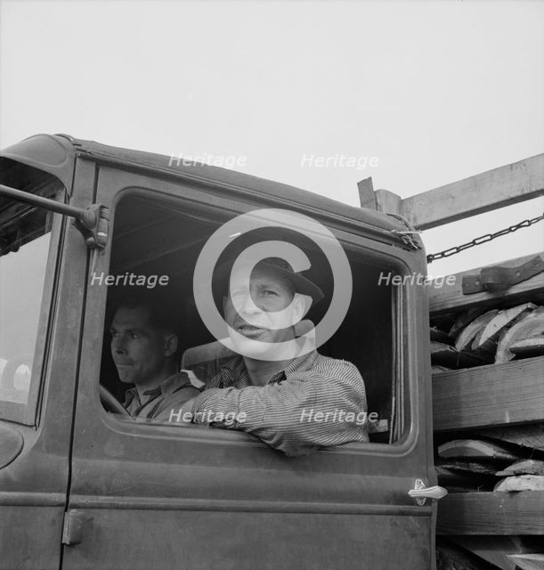 Stump farmer hauling load of slab wood for sale in town, Bonner County, Idaho, 1939. Creator: Dorothea Lange.