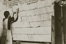 Stacking unleavened bread for the Passover in a Jewish bakery, 20th century