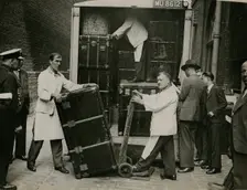 Staff from Bishop & Sons Depositories Ltd unload a case at Burlington House, 1935. Creator: Topical Press Agency