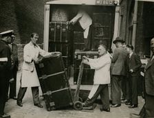 Staff from Bishop & Sons Depositories Ltd unload a case at Burlington House, 1935. Creator: Topical Press Agency