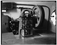 Stamping machine at Treasury, between 1910 and 1920. Creator: Harris & Ewing