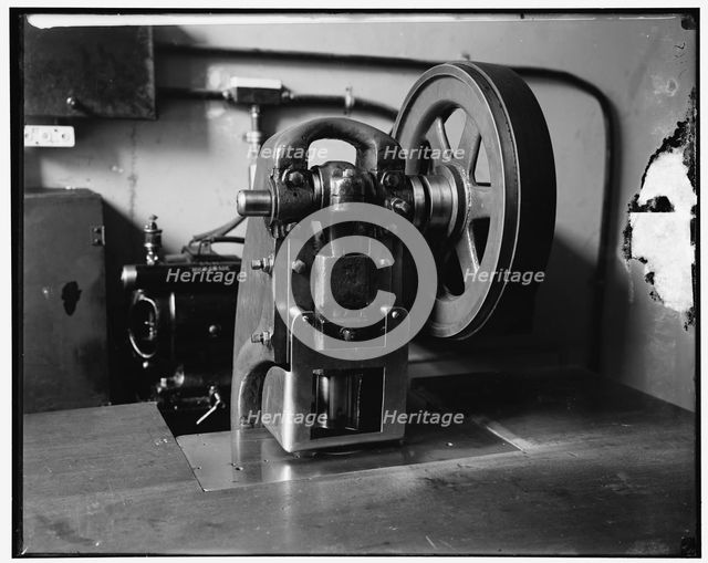 Stamping machine at Treasury, between 1910 and 1920. Creator: Harris & Ewing.