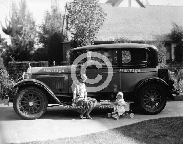 Stan Laurel at the wheel of 1927 Hupmobile with his wife Lois and daughter Lois  Artist: Unknown.