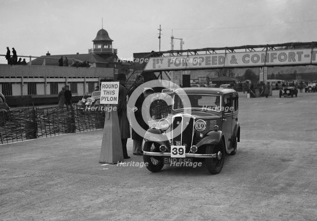 Standard Nine saloon competing in the JCC Rally, Brooklands, Surrey, 1939. Artist: Bill Brunell.