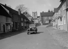 Standard Sixteen saloon driving down the High Street, Hambledon, Hampshire, 1930s. Artist: Bill Brunell