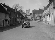 Standard Sixteen saloon driving down the High Street, Hambledon, Hampshire, 1930s. Artist: Bill Brunell