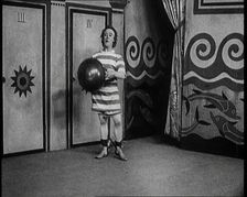 Stanley Lupino Performing in a Show in London Wearing a Stripy Bathing Suit, 1922. Creator: British Pathe Ltd