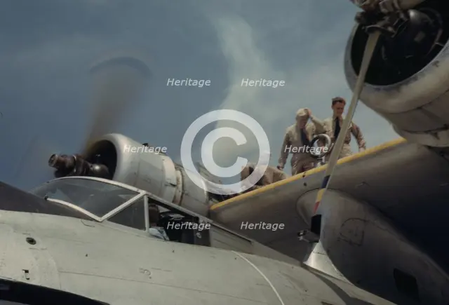 Starting a propeller at the Naval Air Base, Corpus Christi, Texas, 1942. Creator: Howard Hollem.