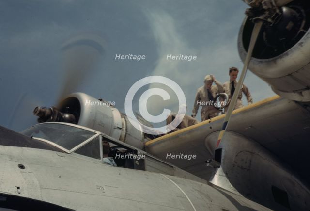 Starting a propeller at the Naval Air Base, Corpus Christi, Texas, 1942. Creator: Howard Hollem.
