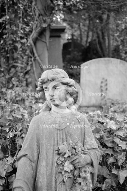 Statue of a girl holding flowers, Highgate Cemetery, Hampstead, London, 1995. Artist: John Gay.