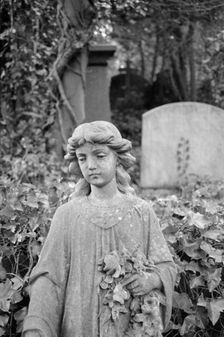 Statue of a girl holding flowers, Highgate Cemetery, Hampstead, London, 1995. Artist: John Gay