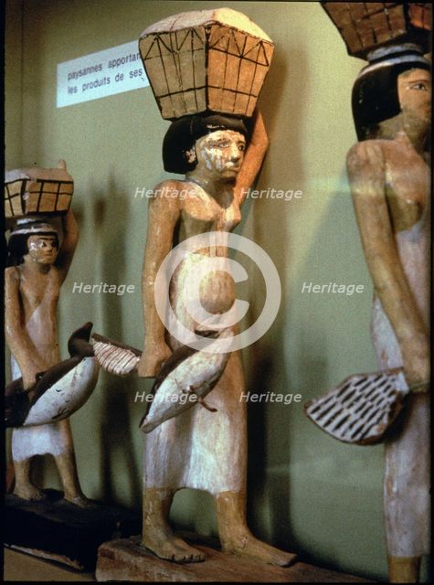 Statue of a peasant woman carrying products of the land to a dead man, made in polychromed wood. …