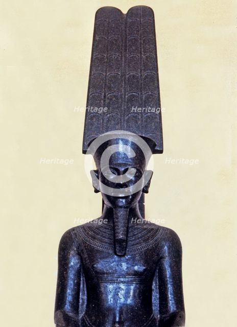 Statue of the god Amon protecting Tutankhamen, made in black granite, 1350 b.C, detail of the top…