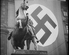 Statue With a Nazi Flag Behind it, 1930s. Creator: British Pathe Ltd