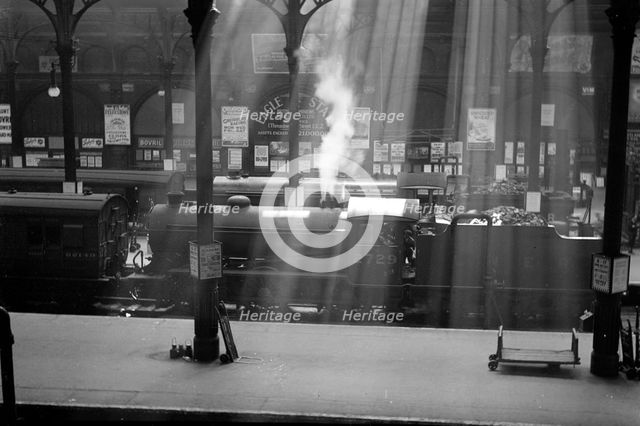 Steam locomotives wait at Liverpool Street Station, London. Artist: Unknown