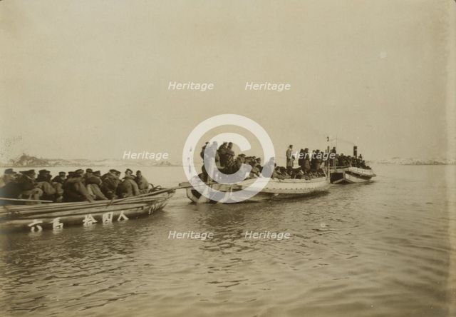 Steam launch carrying six over-crowded boat loads soldiers to landing, Chemulpo, c1904. Creator: Robert Lee Dunn.