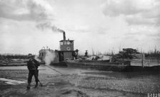 Steamer Little Delta and barge on sand bar, between c1900 and c1930. Creator: Unknown