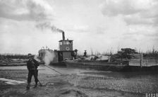 Steamer Little Delta and barge on sand bar, between c1900 and c1930. Creator: Unknown