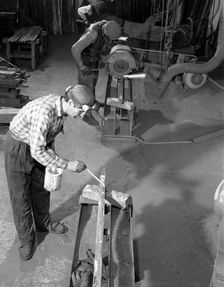 Steel bars being cut to size at J Beardshaw & Sons, Sheffield, South Yorkshire, 1963. Creator: Michael Walters