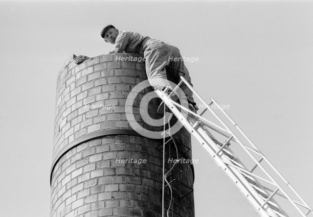 steeplejack up a 6 metre high chimney, Landskrona, Sweden, 1967. Creator: Unknown.
