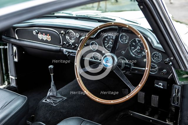 Steering wheel and dashboard of a 1961 Aston Martin DB4 GT previously owned by Donald Campbell. Creator: Unknown.