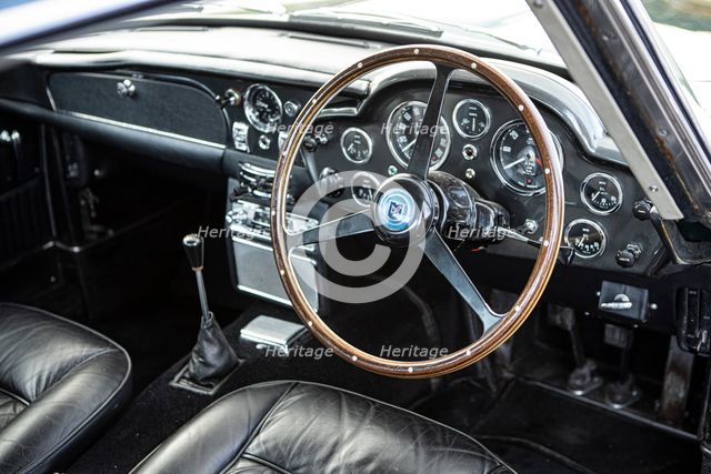 Steering wheel and dashboard of a 1965 Aston Martin DB5. Creator: Unknown.