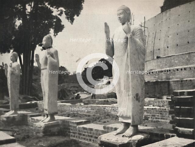 'Steinstatuen vor der in Wiederherstellung befindlichen Ruwanwali-Dagoba, Anuradhapura', 1926. Artist: Unknown.
