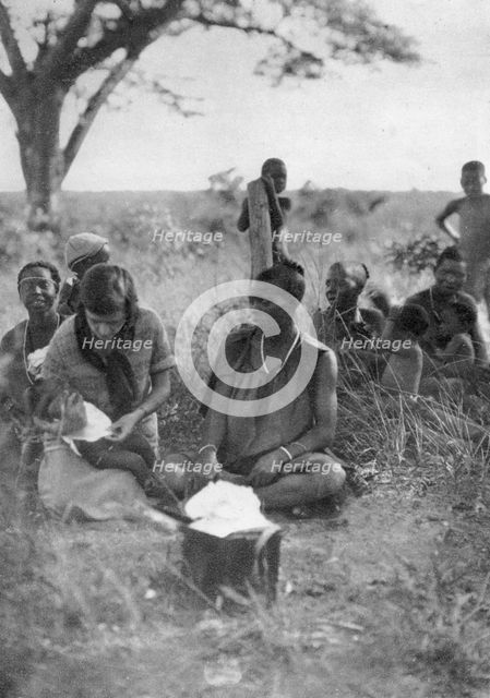 Stella Court Treatt tending a sick baby, Bulawayo to Dett, Southern Rhodesia, c1924-c1925 (1927). Artist: Thomas A Glover