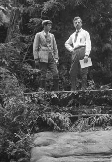 Sterling, George, and Porter Garnett, standing...at the Bohemian Grove, Sonoma, Ca., c1906-1911. Creator: Arnold Genthe