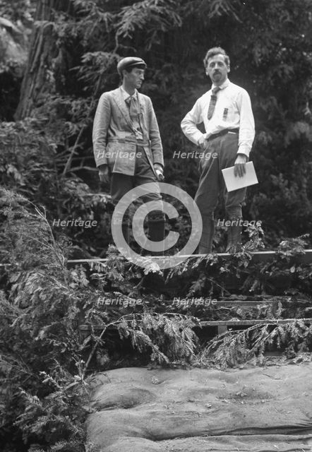 Sterling, George, and Porter Garnett, standing...at the Bohemian Grove, Sonoma, Ca., c1906-1911. Creator: Arnold Genthe.