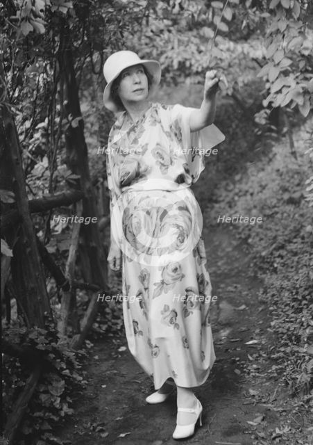 Stettheimer, Florine, Miss, standing outdoors, 1931 Aug. 19. Creator: Arnold Genthe.