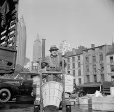 Stevedore who packs and loads crates of fish on the lower east side, 1943. Creator: Gordon Parks
