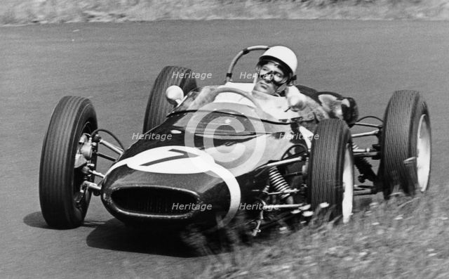 Stirling Moss taking a bend in a racing car, (c1960-c1961?). Artist: Unknown