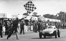 Stirling Moss winning 1957 British Grand Prix at Aintree in the Vanwall. Creator: Unknown