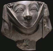 Stone corbel in the shape of a smiling nun, medieval, 14th century