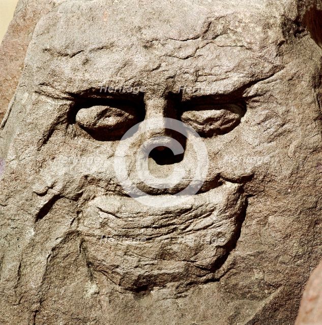 Stone head from pagan Celtic shrine at Cinderford, Gloucestershire. Artist: Unknown