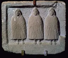 Stone relief of a trio of hooded Romano-British deities, 3rd century