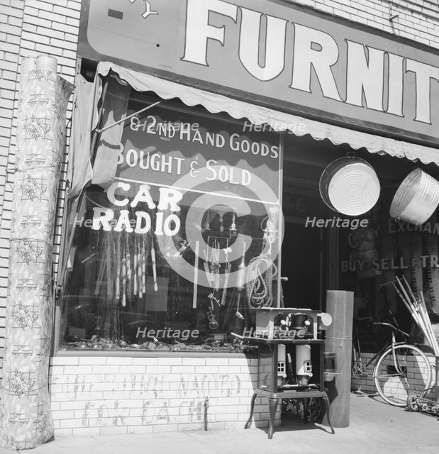 Storefront of San Joaquin Valley town, Fresno, on U.S. 99, California, 1939. Creator: Dorothea Lange.