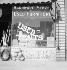 Storefront of San Joaquin Valley town, Fresno, on U.S. 99, California, 1939. Creator: Dorothea Lange